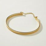 gold cuff bracelet, flat bangle bracelet, open cuff bracelet, minimalist gold bracelet, bracelet with chain closure, safety chain bracelet, stackable bangle, polished gold cuff, thin gold cuff bracelet, modern gold bracelet, everyday gold bracelet, wrist stack jewelry, gift for her
