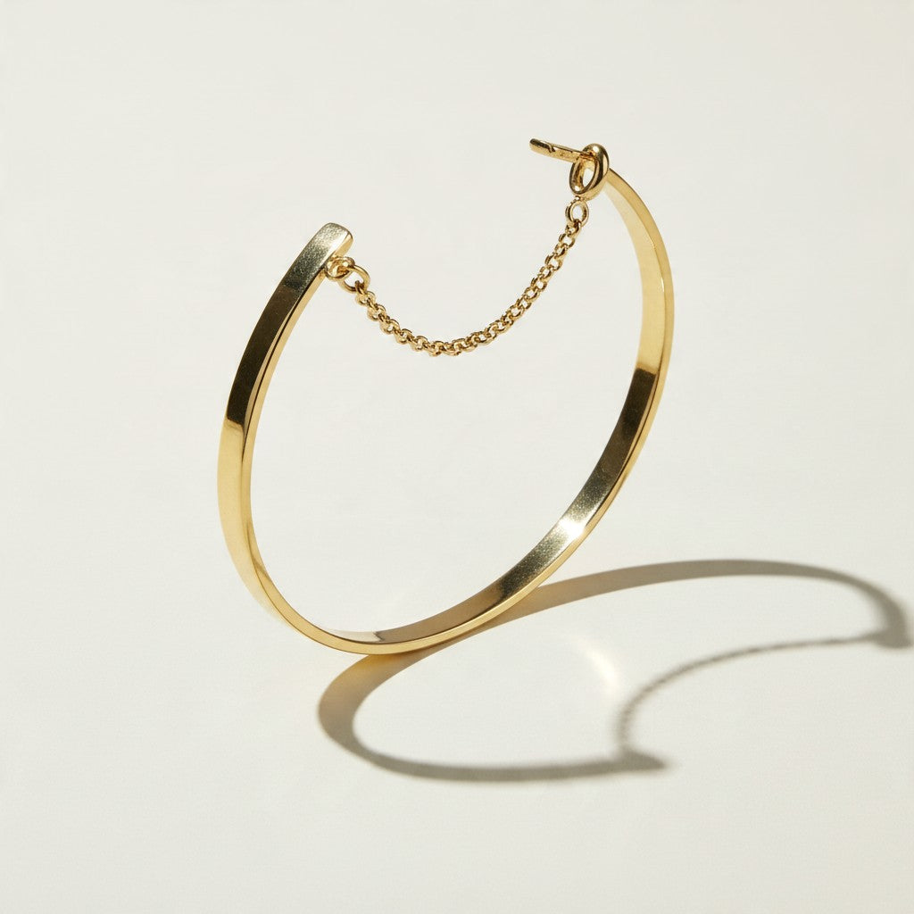 gold cuff bracelet, flat bangle bracelet, open cuff bracelet, minimalist gold bracelet, bracelet with chain closure, safety chain bracelet, stackable bangle, polished gold cuff, thin gold cuff bracelet, modern gold bracelet, everyday gold bracelet, wrist stack jewelry, gift for her