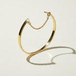 gold cuff bracelet, flat bangle bracelet, open cuff bracelet, minimalist gold bracelet, bracelet with chain closure, safety chain bracelet, stackable bangle, polished gold cuff, thin gold cuff bracelet, modern gold bracelet, everyday gold bracelet, wrist stack jewelry, gift for her