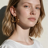 gold flat hoop earrings on model, wide band hoop earrings, medium gold hoop earrings, textured gold hoops, polished gold hoop earrings, modern hoop earrings, statement hoops, everyday gold hoops, minimalist hoop earrings, hoop earrings for bob hair, gift for her, linen summer style jewelry