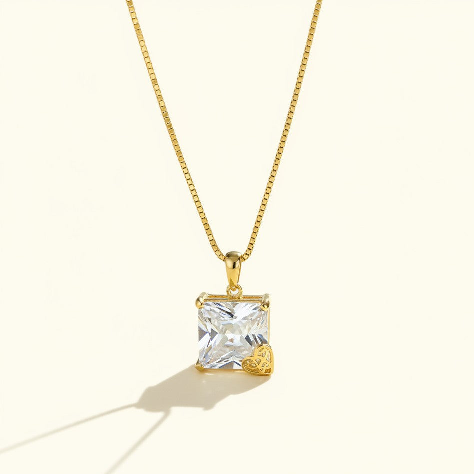 princess cut pendant necklace, crystal solitaire necklace, heart charm pendant, gold box chain necklace, square cut crystal necklace, statement solitaire pendant, dainty heart accent necklace
