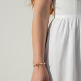 pearl charm bracelet, pearl bracelet on model, gold chain pearl bracelet with charm, dainty pearl bracelet, layering pearl bracelet, pearl bracelet lifestyle, pearl bracelet dangle detail, everyday pearl bracelet