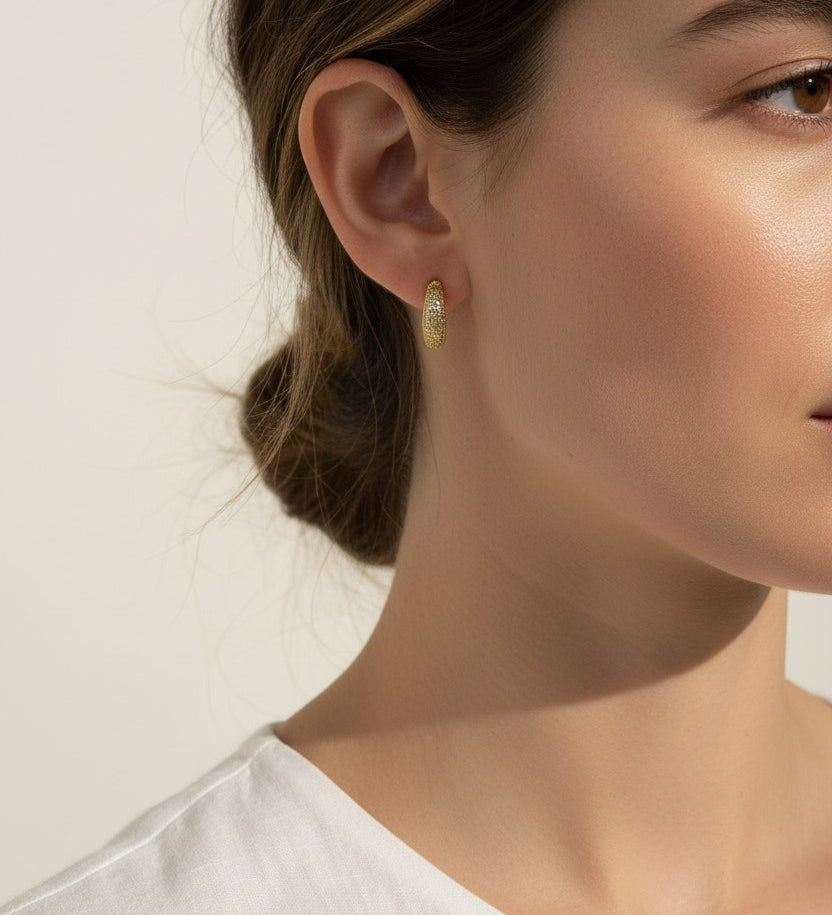 textured gold hoop earrings, stardust gold earrings, granulated gold huggie hoops, textured dome earrings on model, gold hoop earrings close-up, sparkly textured hoops, tapered gold huggie earrings, everyday gold hoop earrings