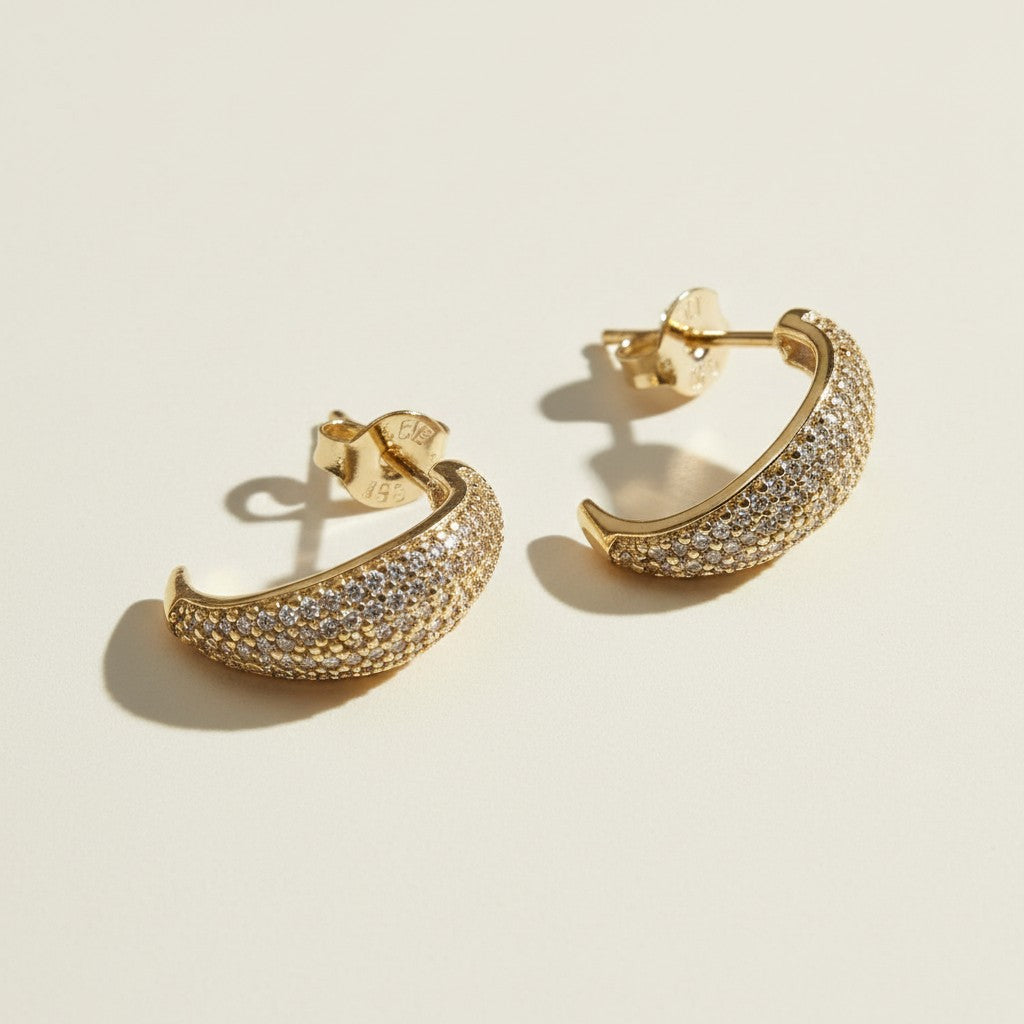 textured gold hoop earrings flat lay, pave dome hoop earrings, sparkly textured hoops detail, micro CZ gold hoops, stardust texture earrings, tapered gold huggie hoops, sugared gold earrings, statement pave hoops