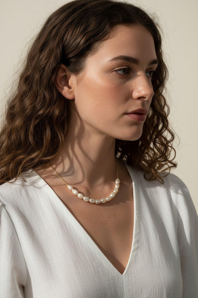 gold pearl cluster necklace on model, freshwater pearl necklace worn, modern pearl necklace styled, pearl necklace with white dress, gold chain pearl necklace, elegant pearl necklace lifestyle, dainty pearl cluster jewelry