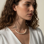gold pearl cluster necklace on model, freshwater pearl necklace worn, modern pearl necklace styled, pearl necklace with white dress, gold chain pearl necklace, elegant pearl necklace lifestyle, dainty pearl cluster jewelry