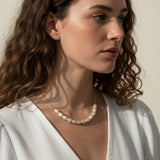 gold pearl cluster necklace on model, freshwater pearl necklace worn, modern pearl necklace styled, pearl necklace with white dress, gold chain pearl necklace, elegant pearl necklace lifestyle, dainty pearl cluster jewelry