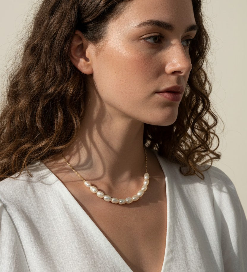 gold pearl cluster necklace on model, freshwater pearl necklace worn, modern pearl necklace styled, pearl necklace with white dress, gold chain pearl necklace, elegant pearl necklace lifestyle, dainty pearl cluster jewelry