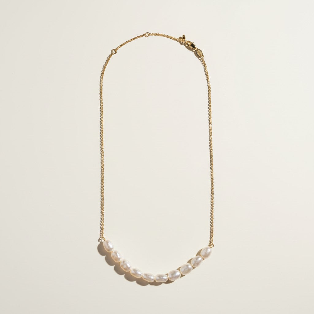 gold pearl cluster necklace, freshwater pearl bar necklace, clustered pearl necklace, modern pearl necklace, gold chain pearl necklace, asymmetric pearl necklace, dainty pearl cluster jewelry, pearl necklace flat lay