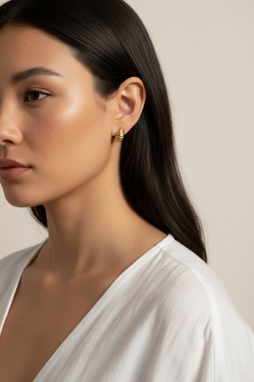 ribbed gold hoop earrings, fluted gold dome earrings, textured gold huggie hoops, ribbed earrings on model, gold hoop earrings close-up, sculptural gold earrings, minimalist ribbed hoops, everyday gold dome earrings
