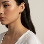 ribbed gold hoop earrings, fluted gold dome earrings, textured gold huggie hoops, ribbed earrings on model, gold hoop earrings close-up, sculptural gold earrings, minimalist ribbed hoops, everyday gold dome earrings