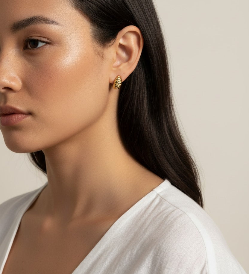 ribbed gold hoop earrings, fluted gold dome earrings, textured gold huggie hoops, ribbed earrings on model, gold hoop earrings close-up, sculptural gold earrings, minimalist ribbed hoops, everyday gold dome earrings