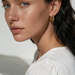 chunky gold huggie hoop earrings, gold dome hoop earrings, thick gold hoops, small gold hoop earrings, everyday gold hoops, polished gold huggies, lightweight chunky hoops, minimalist gold earrings, classic hoop earrings, earrings for stacking, gift for her, gold hoop earrings on model