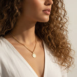 gold coin pendant necklace worn, curb chain medallion necklace styled, vintage coin necklace fit, engraved coin pendant lifestyle photo, gold medallion necklace close-up, classical figure coin necklace