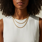 layered chain necklaces, gold chain stack, herringbone and curb chain layered, 18K gold overlay necklaces, layered necklace set on-model, mixed chain necklace stack, gold necklace layering, chain necklace trio