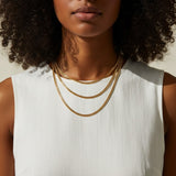 layered chain necklaces, gold chain stack, herringbone and curb chain layered, 18K gold overlay necklaces, layered necklace set on-model, mixed chain necklace stack, gold necklace layering, chain necklace trio