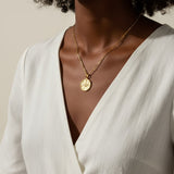 protected necklace, evil eye coin pendant necklace, gold word necklace, medallion necklace gold, layered gold necklace, symbolic jewelry, protective jewelry, double chain necklace