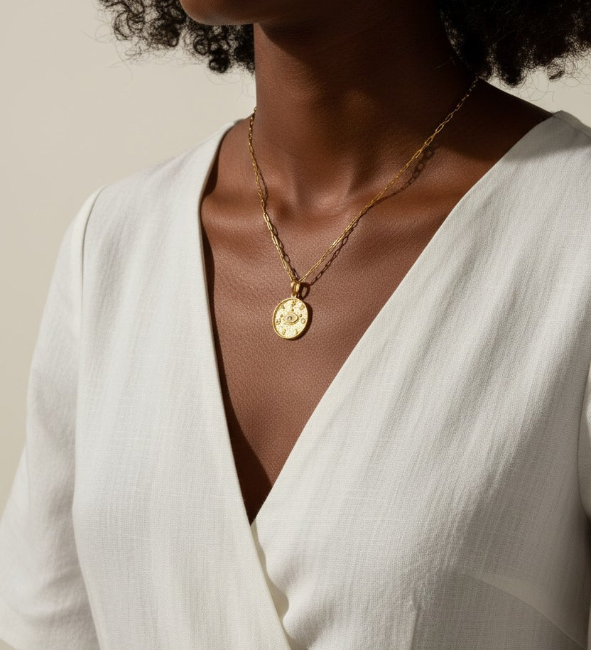 protected necklace, evil eye coin pendant necklace, gold word necklace, medallion necklace gold, layered gold necklace, symbolic jewelry, protective jewelry, double chain necklace