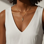 lightning bolt pendant necklace, pave crystal lightning bolt, gold bolt charm necklace, figaro chain necklace, statement pendant detail, crystal encrusted pendant, edgy gold necklace, lightning bolt jewelry