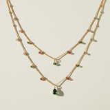 layered gemstone necklace, multicolor beaded chain necklace, gold layered necklace set, gemstone drop pendant necklace, emerald pink black crystal necklace, dainty beaded necklace, layered necklace colorways, gold chain necklace detail