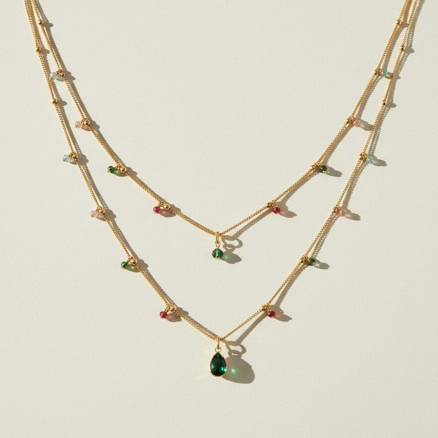 layered gemstone necklace, multicolor beaded chain necklace, gold layered necklace set, gemstone drop pendant necklace, emerald pink black crystal necklace, dainty beaded necklace, layered necklace colorways, gold chain necklace detail