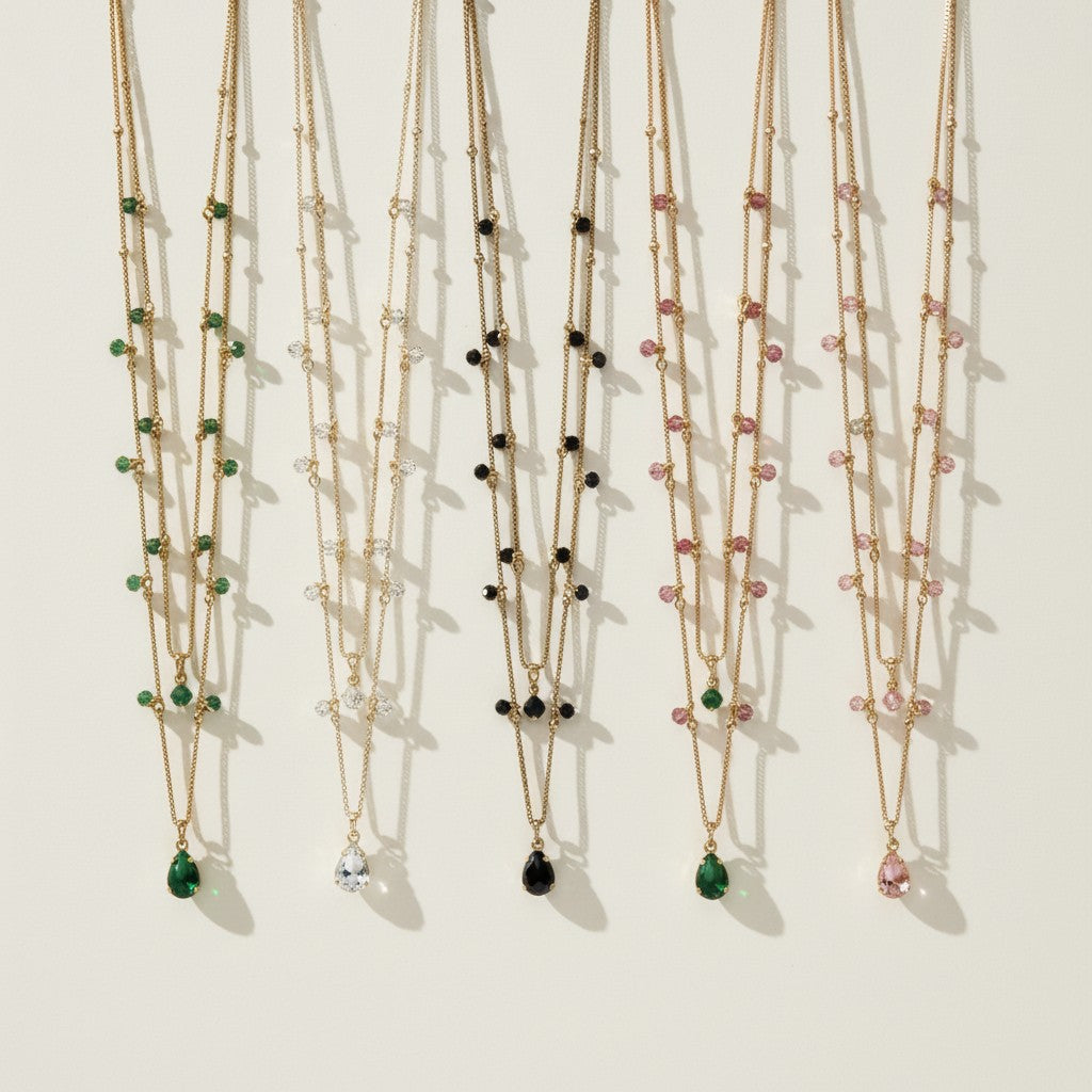layered gemstone necklace, multicolor beaded chain necklace, gold layered necklace set, gemstone drop pendant necklace, emerald pink black crystal necklace, dainty beaded necklace, layered necklace colorways, gold chain necklace detail