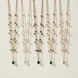 layered gemstone necklace, multicolor beaded chain necklace, gold layered necklace set, gemstone drop pendant necklace, emerald pink black crystal necklace, dainty beaded necklace, layered necklace colorways, gold chain necklace detail