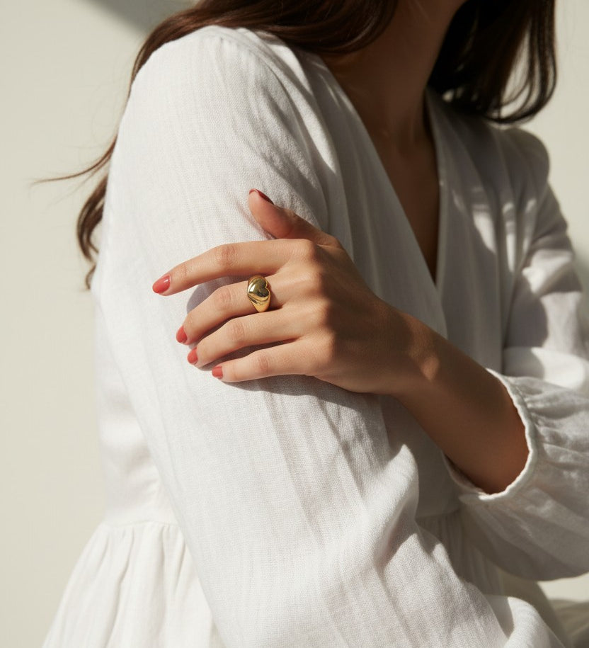 heart signet ring on model, gold heart ring lifestyle, chunky heart ring styled, adjustable open ring on hand, textured gold ring outfit, dome band heart ring, statement heart jewelry, romantic gold ring