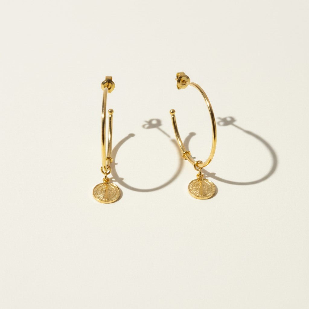 gold coin charm earrings, coin hoop earrings, gold hoop earrings with charm, vintage coin jewelry, dangle hoop earrings flat lay, medallion earrings, engraved coin earrings, everyday gold jewelry