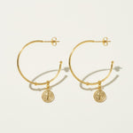gold coin charm earrings, coin hoop earrings, gold hoop earrings with charm, vintage coin jewelry, dangle hoop earrings flat lay, medallion earrings, engraved coin earrings, everyday gold jewelry