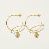 gold coin charm earrings, coin hoop earrings, gold hoop earrings with charm, vintage coin jewelry, dangle hoop earrings flat lay, medallion earrings, engraved coin earrings, everyday gold jewelry