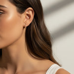 pavé huggie hoop earrings, gold huggie earrings on model, stacked hoop earrings, small pavé hoop earrings, everyday gold hoops, ear stack earrings, sparkle huggie hoops, minimalist gold hoops