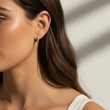 pavé huggie hoop earrings, gold huggie earrings on model, stacked hoop earrings, small pavé hoop earrings, everyday gold hoops, ear stack earrings, sparkle huggie hoops, minimalist gold hoops