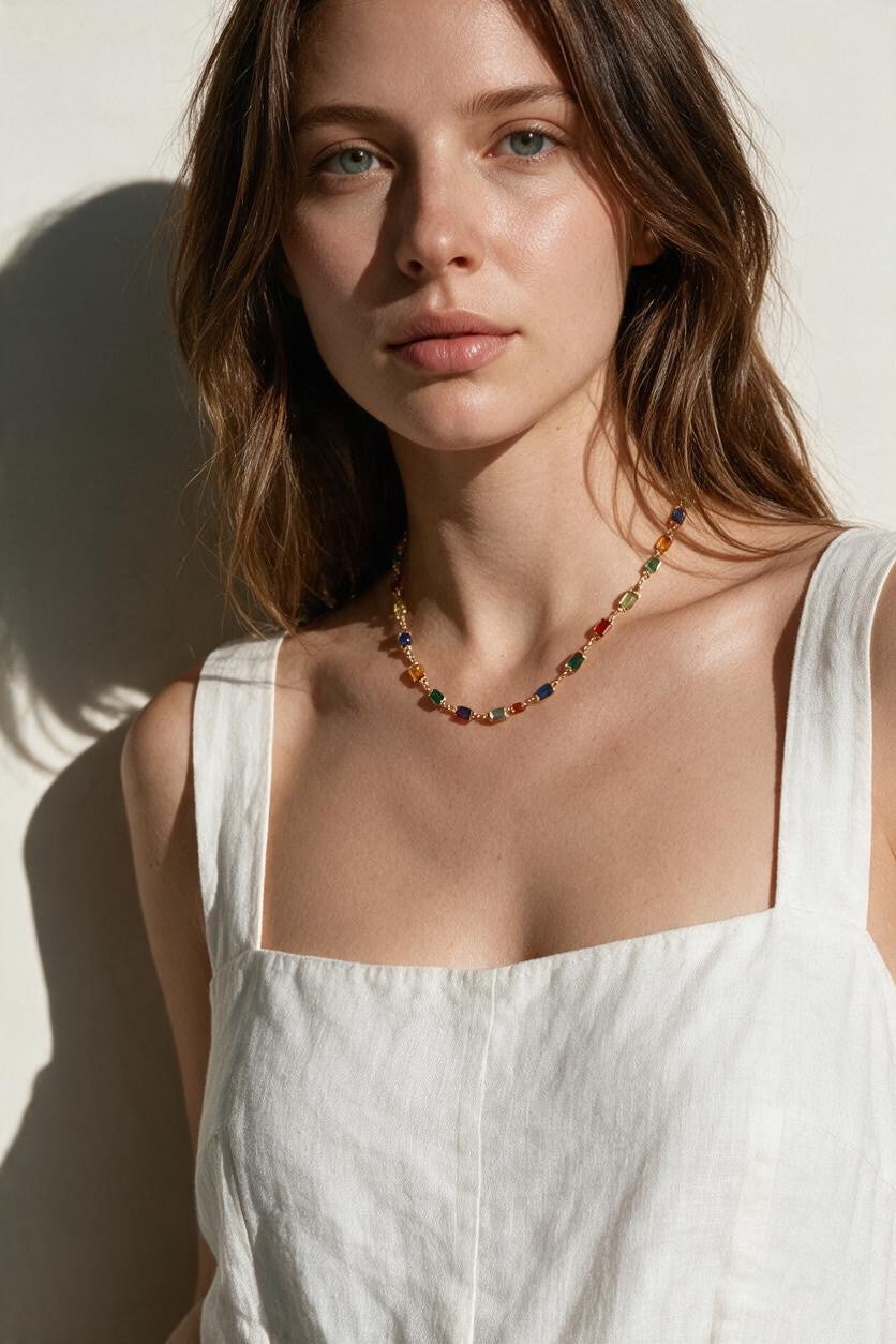 rainbow station necklace on model, colorful gemstone necklace, multicolor bezel necklace, gold station necklace, dainty colorful necklace, jewel tone necklace, emerald cut crystal necklace, summer layering necklace, collarbone length necklace, minimalist color necklace, white linen outfit jewelry, women’s rainbow necklace