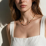 rainbow station necklace on model, colorful gemstone necklace, multicolor bezel necklace, gold station necklace, dainty colorful necklace, jewel tone necklace, emerald cut crystal necklace, summer layering necklace, collarbone length necklace, minimalist color necklace, white linen outfit jewelry, women’s rainbow necklace