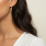 baguette crystal earrings, crystal drop earrings, pave drop earrings gold, dainty crystal earrings, statement drop earrings, sparkly stud and drop earrings, 18K gold overlay earrings, crystal earrings on-model