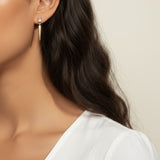 baguette crystal earrings, crystal drop earrings, pave drop earrings gold, dainty crystal earrings, statement drop earrings, sparkly stud and drop earrings, 18K gold overlay earrings, crystal earrings on-model