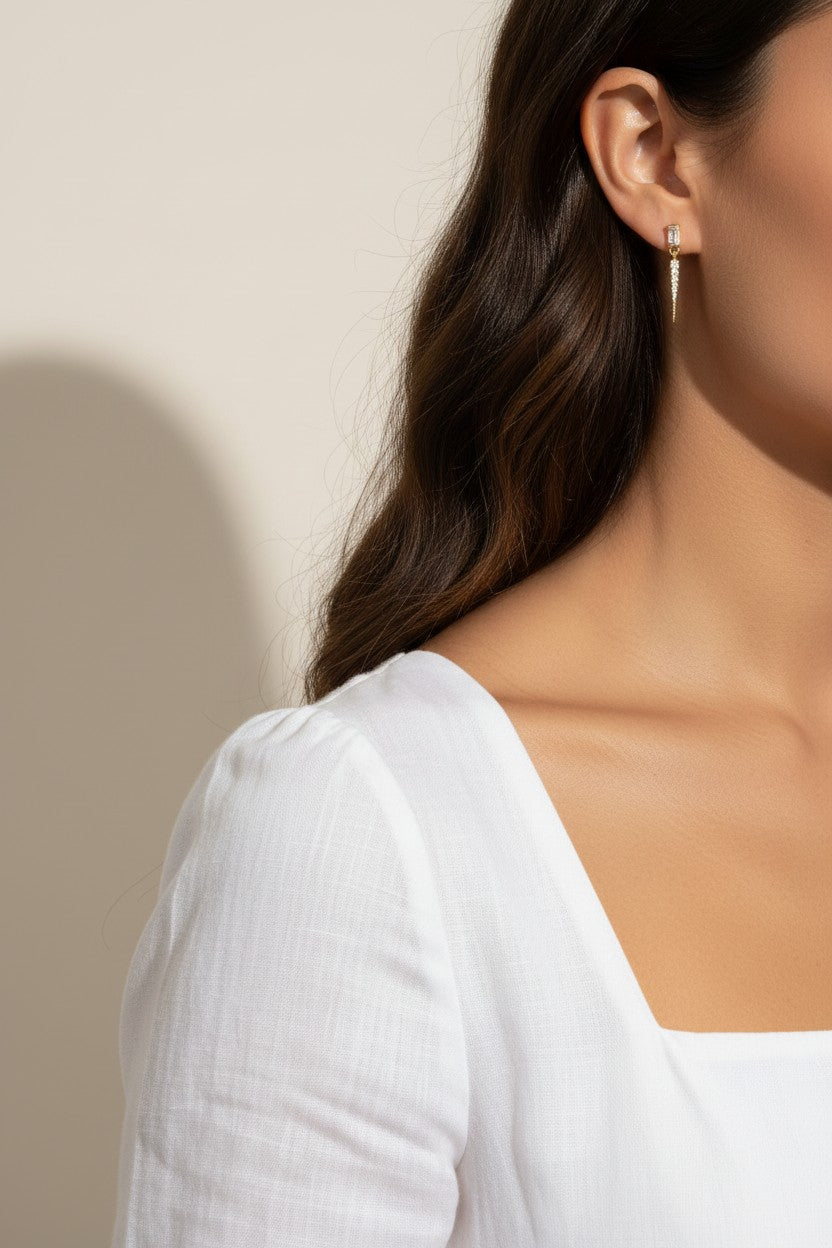 baguette crystal earrings, crystal drop earrings, pave drop earrings gold, dainty crystal earrings, statement drop earrings, sparkly stud and drop earrings, 18K gold overlay earrings, crystal earrings on-model