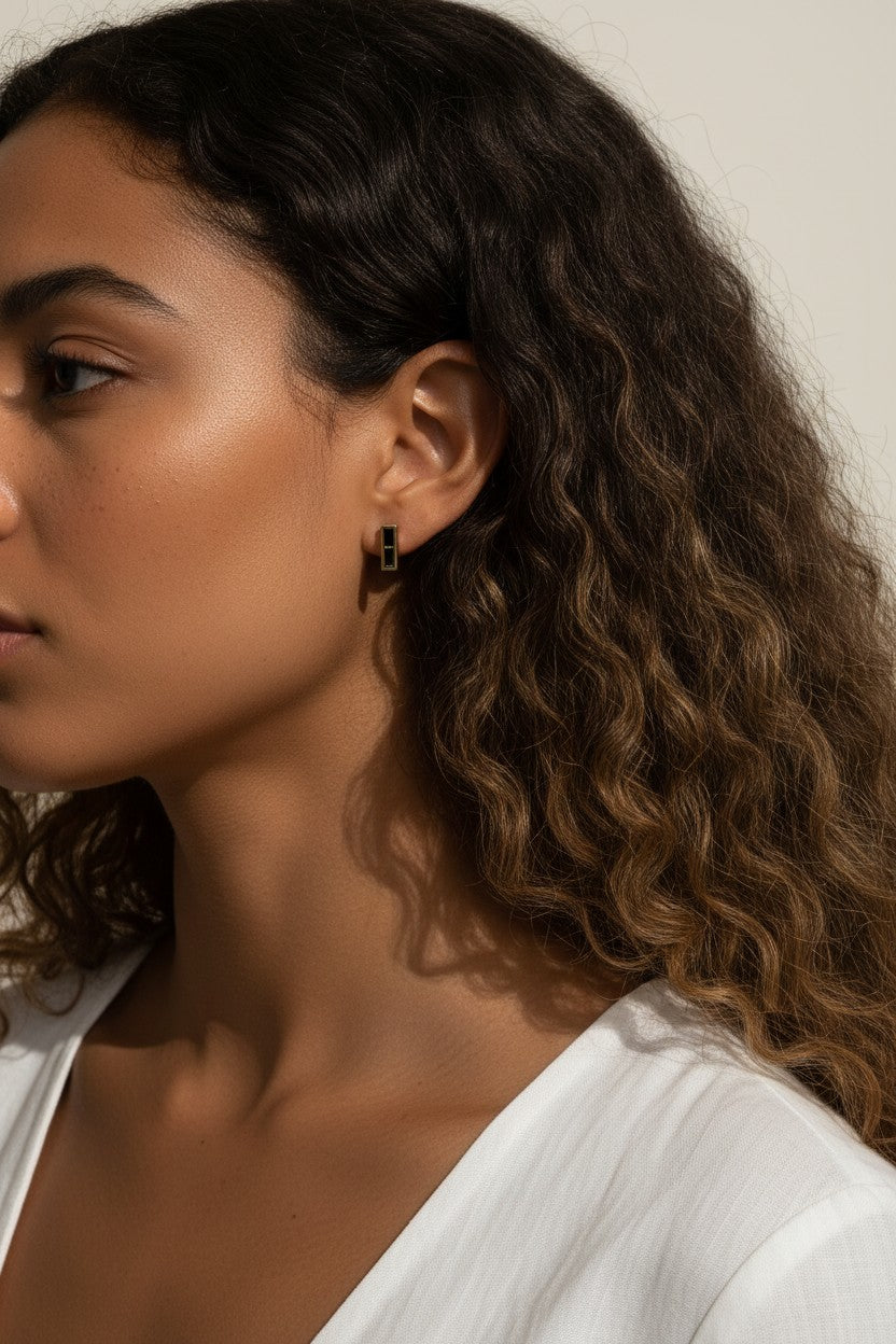 gold bar stud earrings on model, baguette stud earrings worn, emerald bar earrings styled, black baguette stud earrings, clear crystal bar earrings on ear, geometric stud earrings lifestyle, minimalist gold studs worn