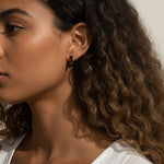 gold bar stud earrings on model, baguette stud earrings worn, emerald bar earrings styled, black baguette stud earrings, clear crystal bar earrings on ear, geometric stud earrings lifestyle, minimalist gold studs worn