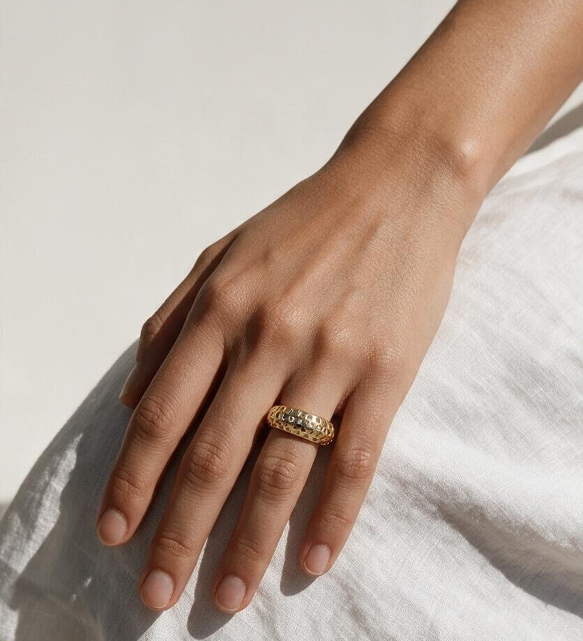 chunky gold dome ring on hand, crystal dome ring, wide gold band ring, statement gold ring, sparkly dome ring, cubic zirconia band ring, thick gold ring, scattered crystal ring, gold stacking ring, bold gold ring, matching ring and earrings, women’s chunky ring