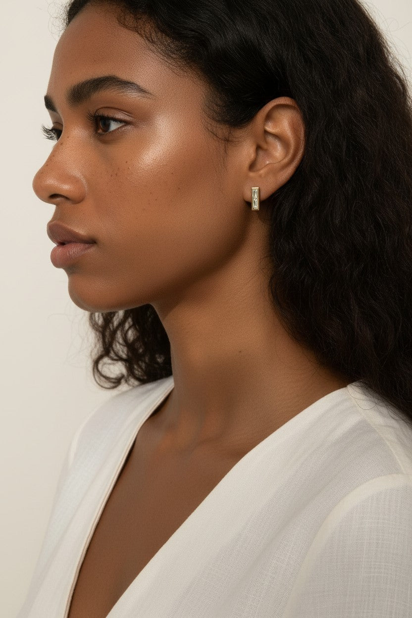 gold bar stud earrings on model, baguette stud earrings worn, emerald bar earrings styled, black baguette stud earrings, clear crystal bar earrings on ear, geometric stud earrings lifestyle, minimalist gold studs worn