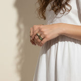 baguette eternity ring stack, gold eternity bands on model, stacked statement rings, emerald and black ring stack, layered baguette rings, gold ring stack lifestyle, colorful eternity bands worn, multi-stone ring stack