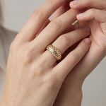 chunky gold dome ring on hand, crystal dome ring, wide gold band ring, statement gold ring, sparkly dome ring, cubic zirconia band ring, thick gold ring, scattered crystal ring, gold stacking ring, bold gold ring, matching ring and earrings, women’s chunky ring