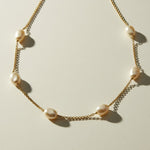 gold pearl station necklace, freshwater pearl chain necklace, pearls by the yard necklace, gold necklace with pearls, dainty pearl necklace, pearl clasp necklace, gold chain pearl jewelry, delicate pearl necklace flat lay