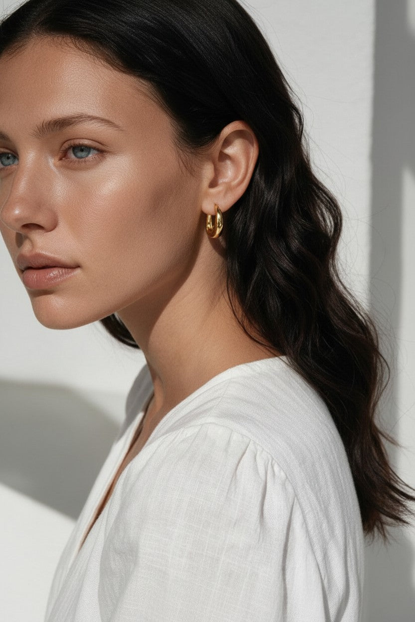 chunky gold huggie hoop earrings, gold dome hoop earrings, thick gold hoops, small gold hoop earrings, everyday gold hoops, polished gold huggies, lightweight chunky hoops, minimalist gold earrings, classic hoop earrings, earrings for stacking, gift for her, gold hoop earrings on model