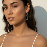 gold coin charm earrings, coin hoop earrings, gold hoop earrings with charm, vintage coin jewelry, dangle hoop earrings, everyday gold earrings, medallion earrings, on-model earring photography
