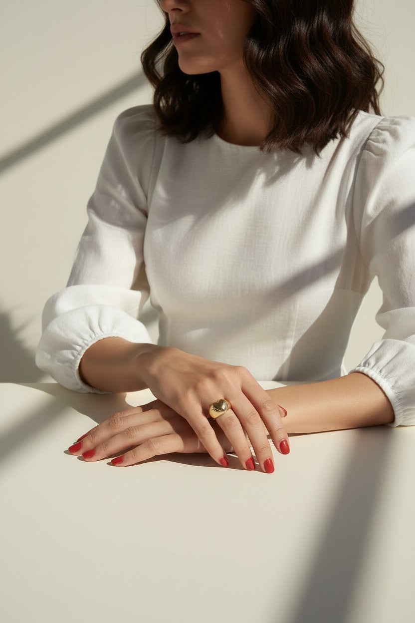 heart signet ring on model, gold heart ring lifestyle, chunky heart ring styled, adjustable open ring on hand, textured gold ring outfit, dome band heart ring, statement heart jewelry, romantic gold ring