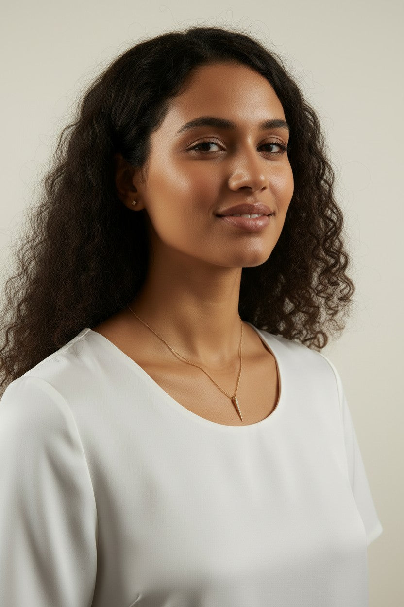 gold dagger necklace worn, pave spike pendant styled, minimalist necklace on model, edgy pendant necklace fit, layering necklace lifestyle photo, dainty gold necklace close-up