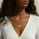 gold wishbone necklace, compass coin pendant necklace, medallion necklace gold, symbolic jewelry, vintage coin necklace, textured gold necklace, lucky charm necklace, layering necklace